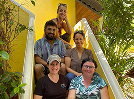 Group of people sitting on stairs. Links to Gifts of Real Estate