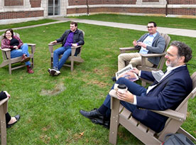 People sitting in chairs and having a discussion. Links to Gifts That Pay You Income