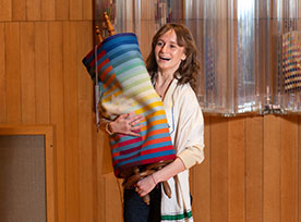 A girl smiling while holding a Toral scroll. Links to Gifts of Cash, Checks, and Credit Cards