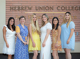 A group of women smiling. Links to Closely Held Business Stock